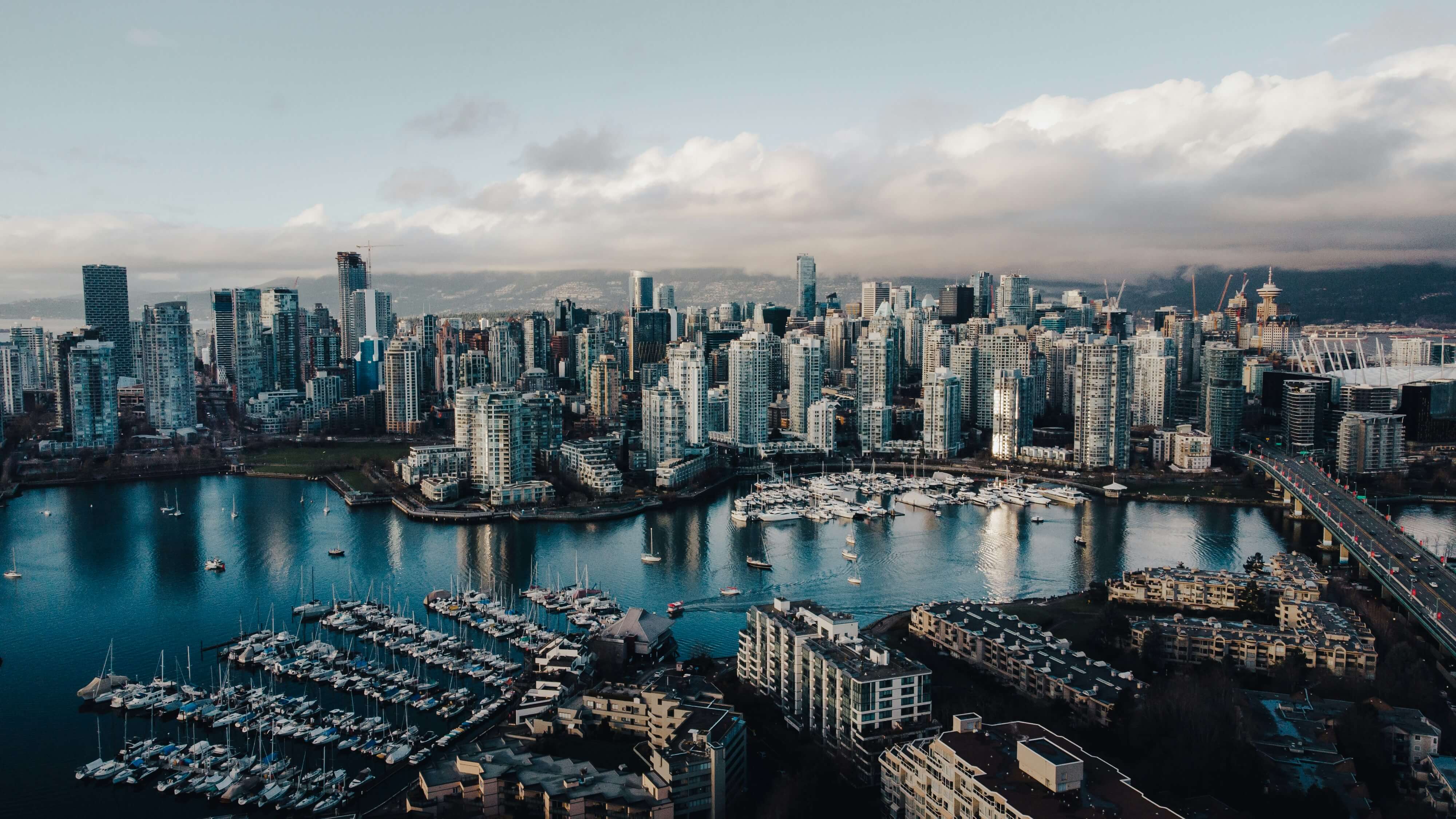 An aerial view of Vancouver, Canada taken from above on a sunny day with blue skies.